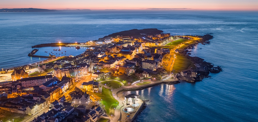 aerial view of the peninsula of portrush at dusk